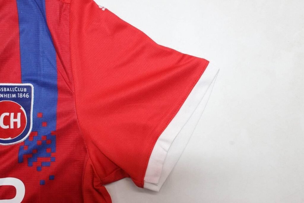 5870a28c_a6888a74-ede8-487f-8d7e-74a54a7c2fe6 CAMISETA HEIDENHEIM I 24/25 HOMBRE (VERSIÓN FAN) - Zona Camisetas