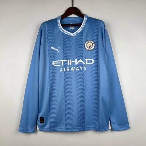MC19_95b27682-f659-4562-9b47-ed63f38e2fbe CAMISETA MANCHESTER CITY I 23/24 HOMBRE MANGA LARGA (VERSIÓN FAN) - Zona Camisetas